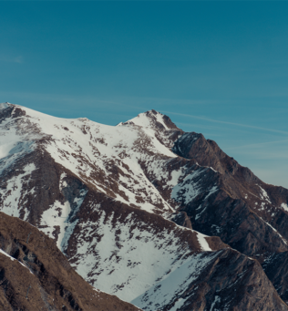 Snowcapped mountain with beautiful blue sky behind it