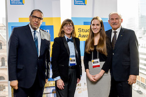 Brittany receiving her award from three department members