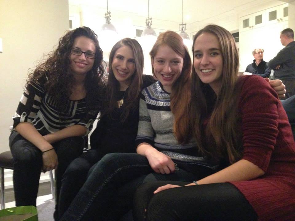 Photograph of four lab members smiling together