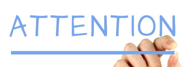 The word "attention" in blue and underlined